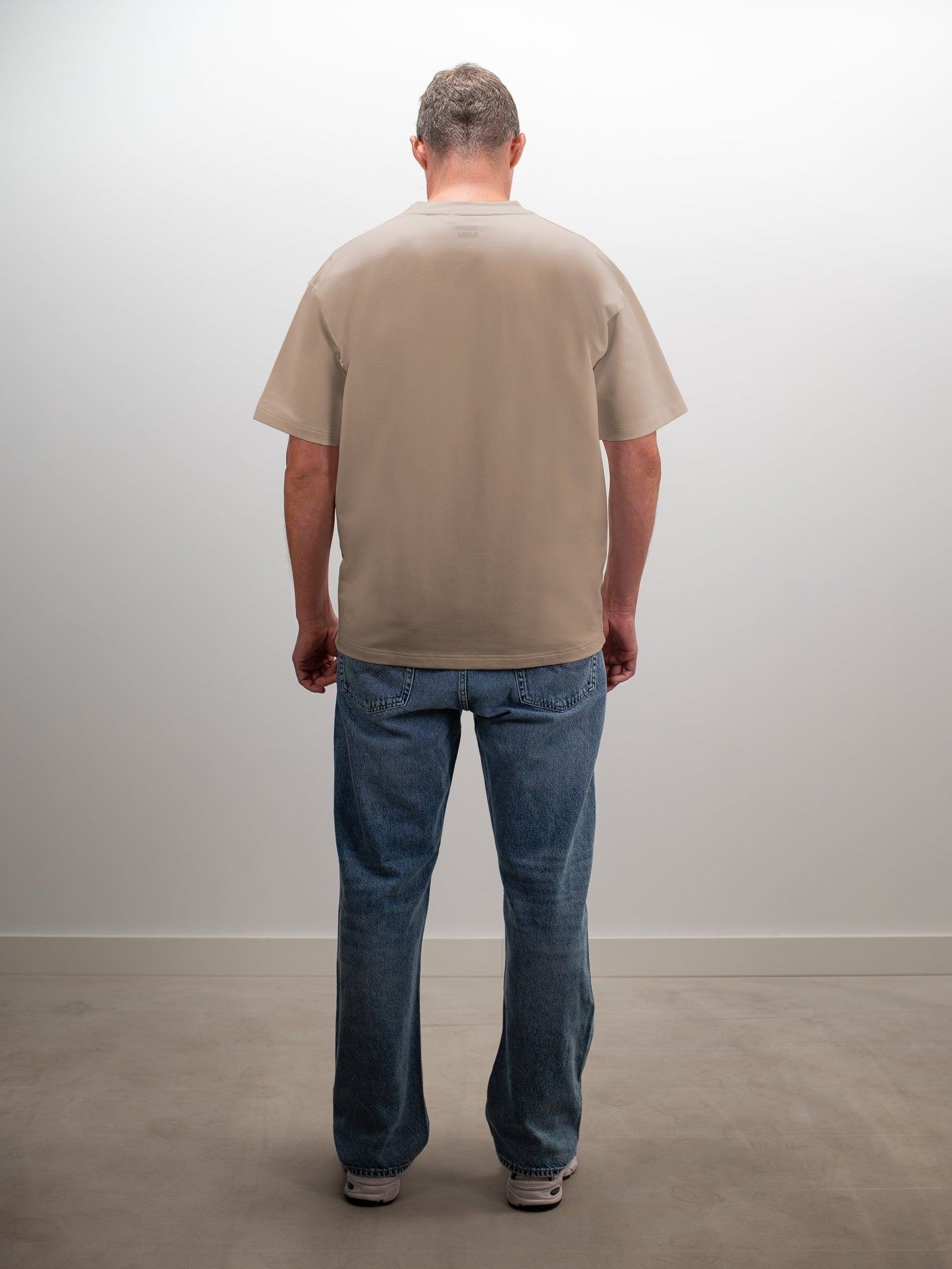 Man draagt het MIKLN Original T-shirt in beige, achterkant